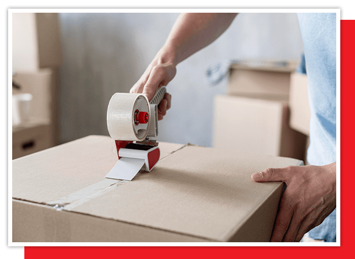 image of a man taping up a box